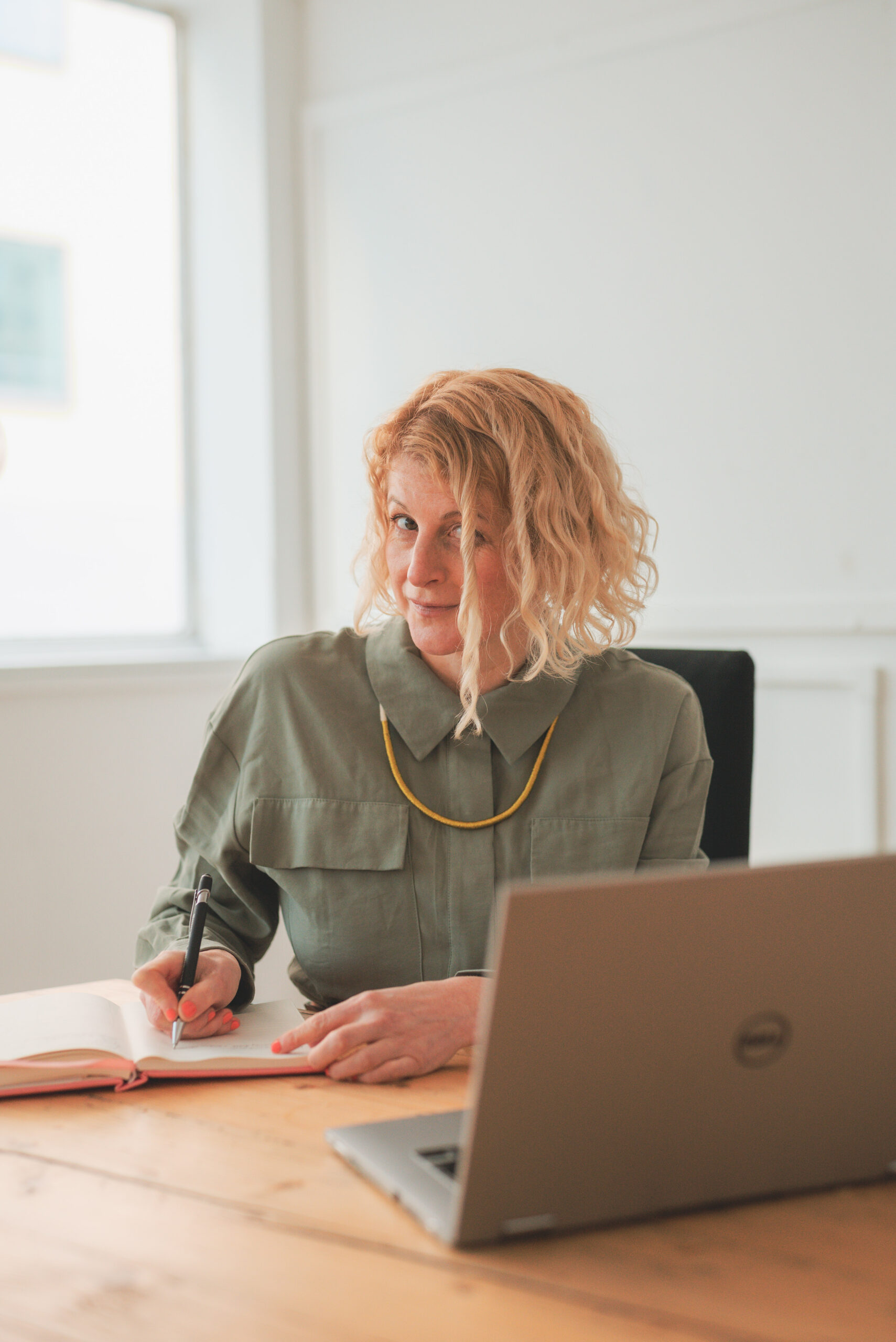 Jen McCanna sitting at desk laptop